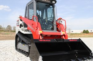 a TL8 front end loader in a gravel parking lot
