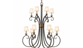 a multi-arm wrought iron chandelier sitting against a black drape