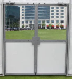 tent doors with a white vinyl bottom, with the top glass reflecting a green field and a building